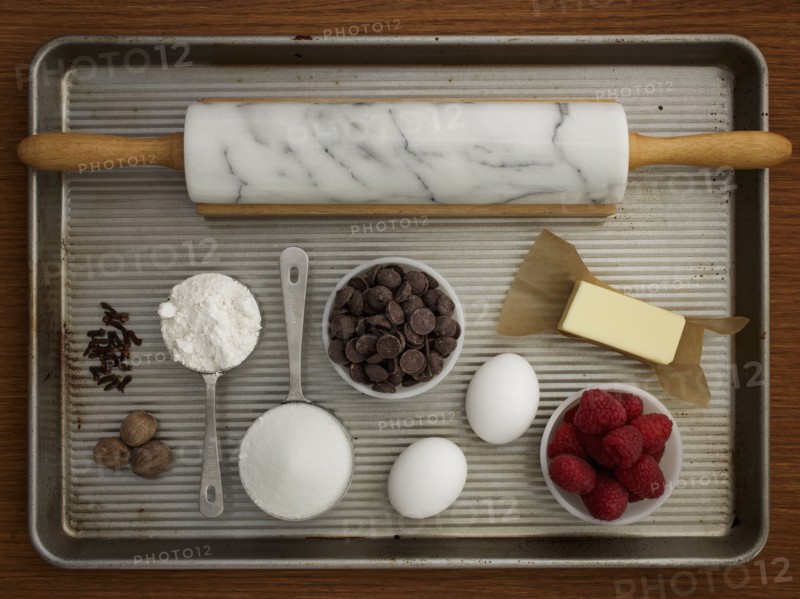 Studio shot of baking sheet with rolling pin and fresh ingredients