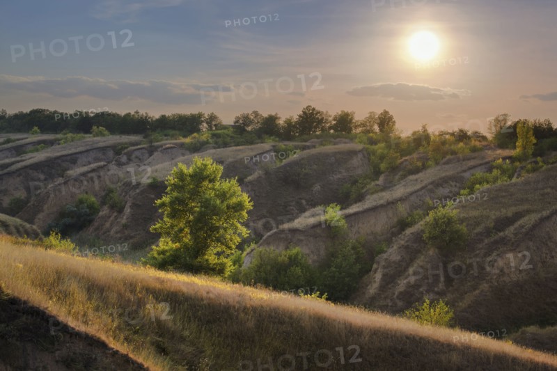 Ukraine, Dnepropetrovsk, Meadow with hills at sunrise