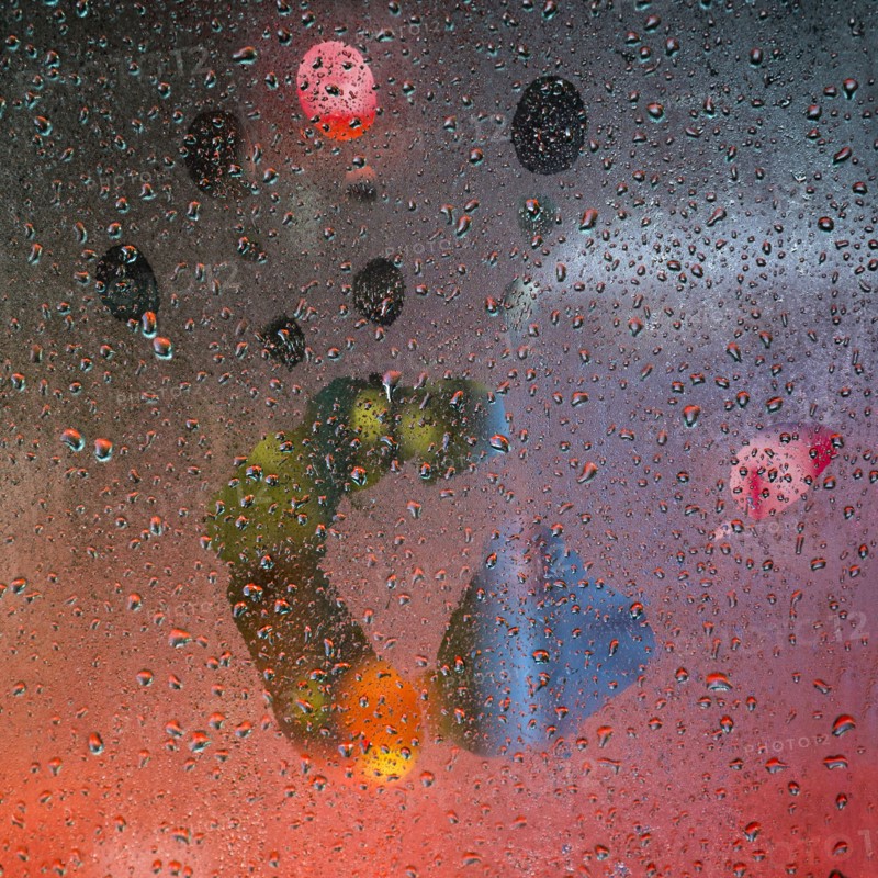Glass with water droplets and handprint