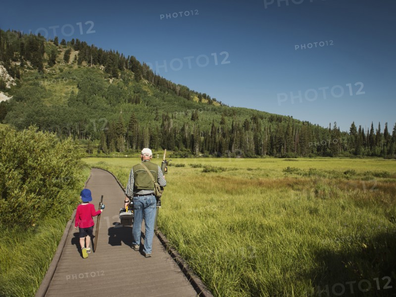 USA, Utah, Lake City, Boy (4-5) with grandfather walking on boardwalk through wetland