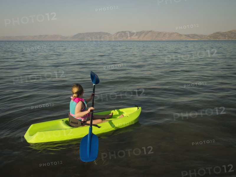 Girl (4-5) kayaking on lake