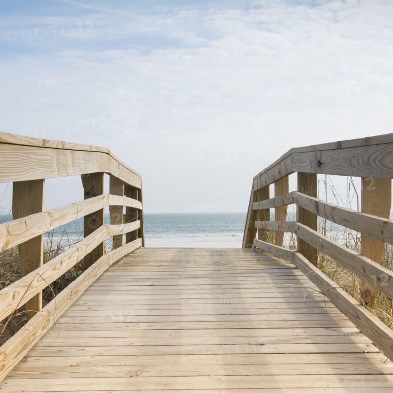 Wooden boardwalk by sea