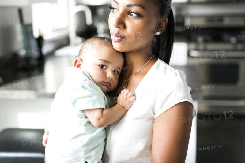 Portrait of mother holding baby boy (2-5 months)