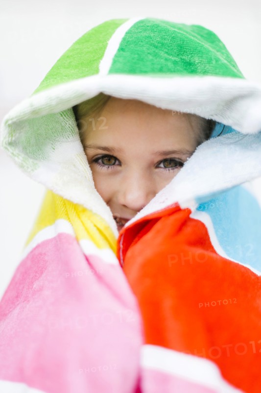 Portrait of smiling girl (4-5) in colorful towel