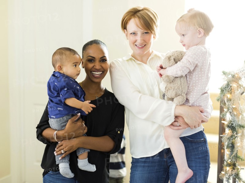 Portrait of mothers holding children (2-5 months, 12-17months)