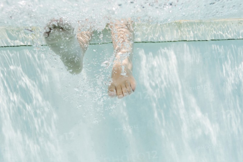 Legs of girl (4-5) underwater