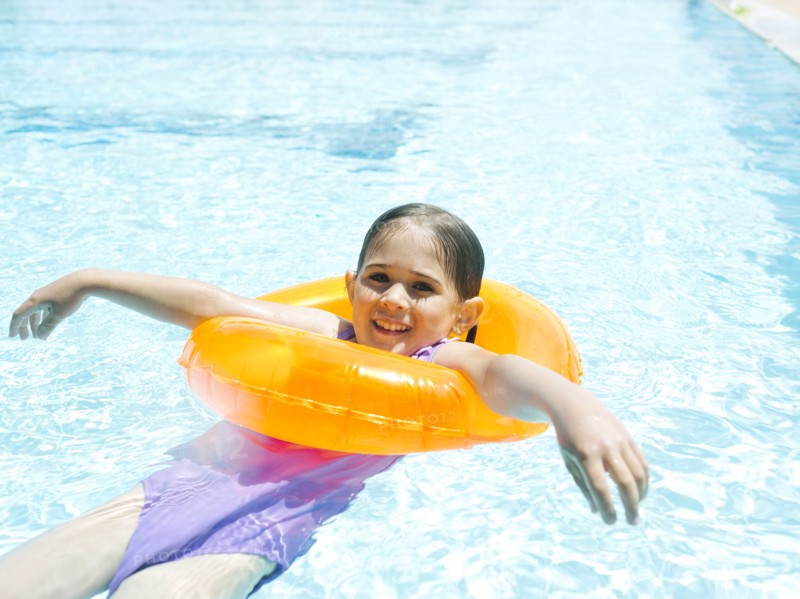 Girl (4-5) swimming in inflatable ring