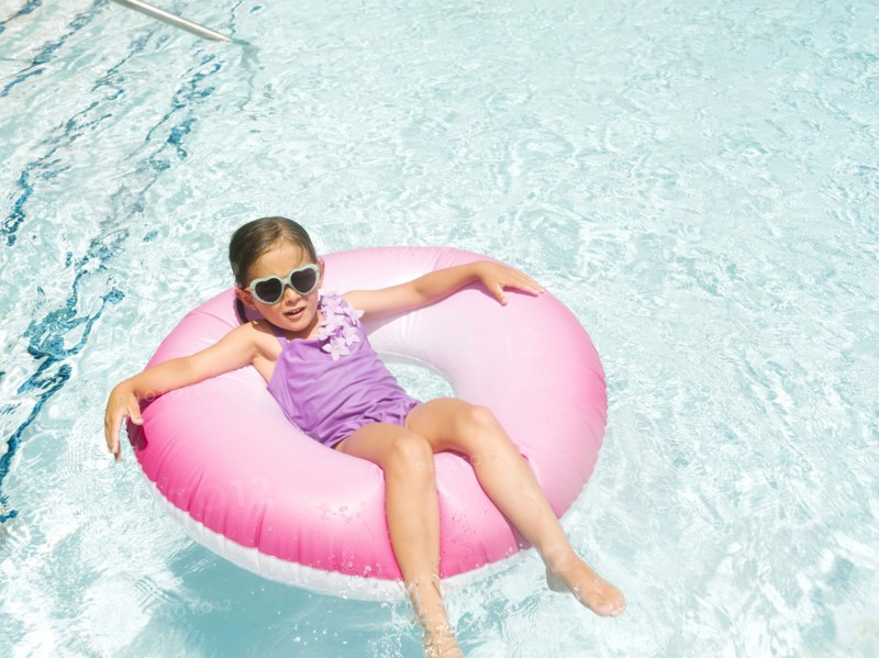 Girl (4-5) relaxing in inflatable ring