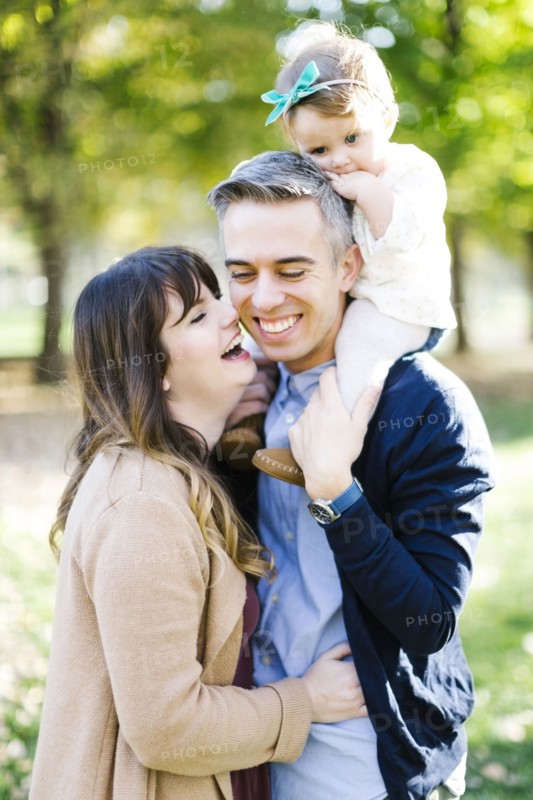 Parents with daughter (12-17 months) in park