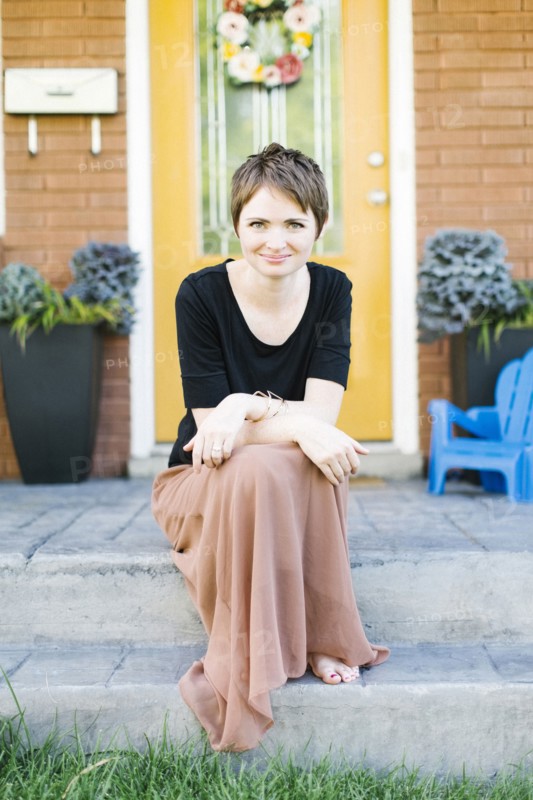 Portrait of woman sitting on step
