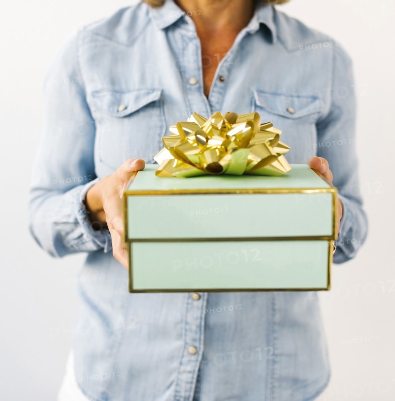 Mid section of Mature woman holding gift
