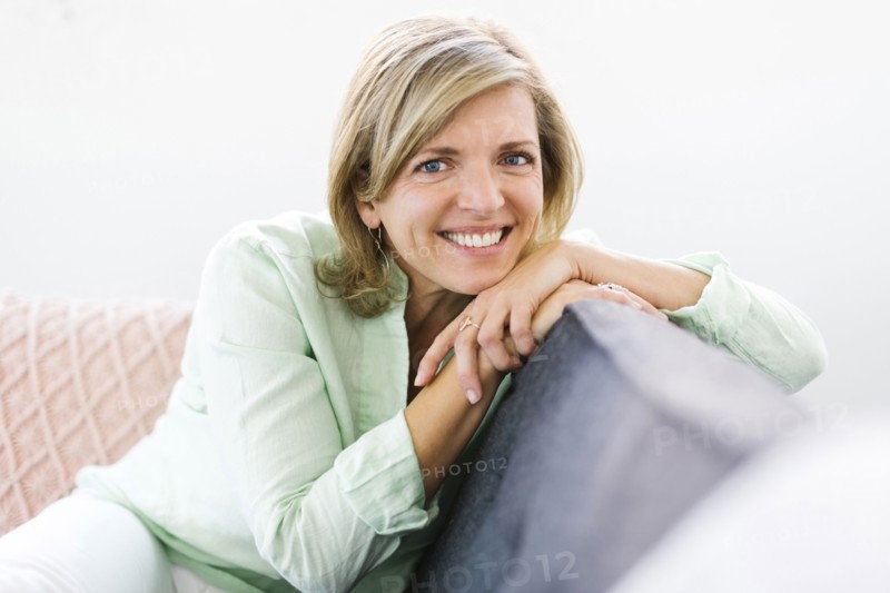 Portrait of woman sitting on sofa
