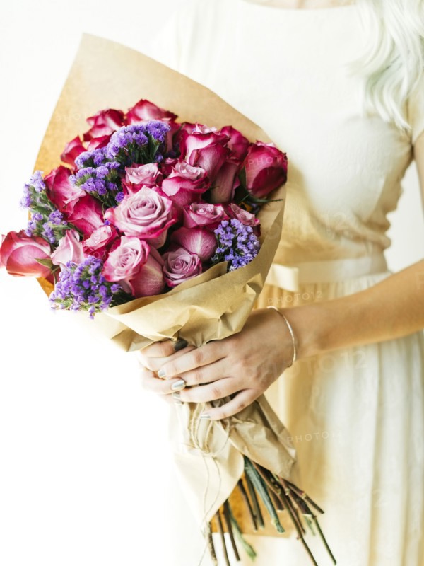Woman holding bouquet with roses