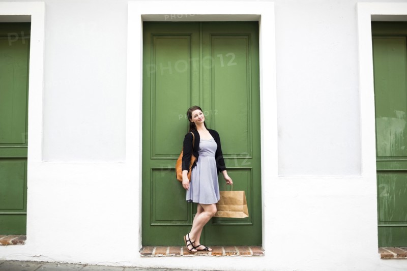 Puerto Rico, San Juan, Woman with shopping bag walking city streets