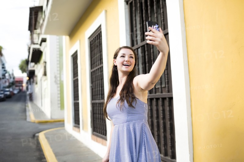 Puerto Rico, San Juan, Beautiful woman doing selfie on city street