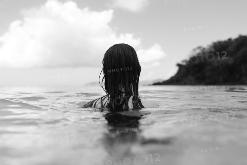 USA, Virgin Islands, Saint Thomas, Woman with long hair standing in bay