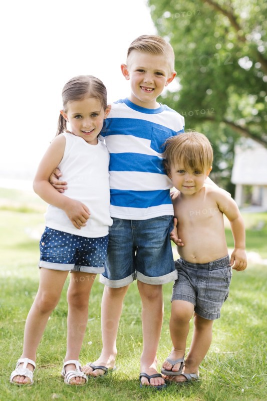 Siblings (2-3, 4-5, 6-7) embracing in park