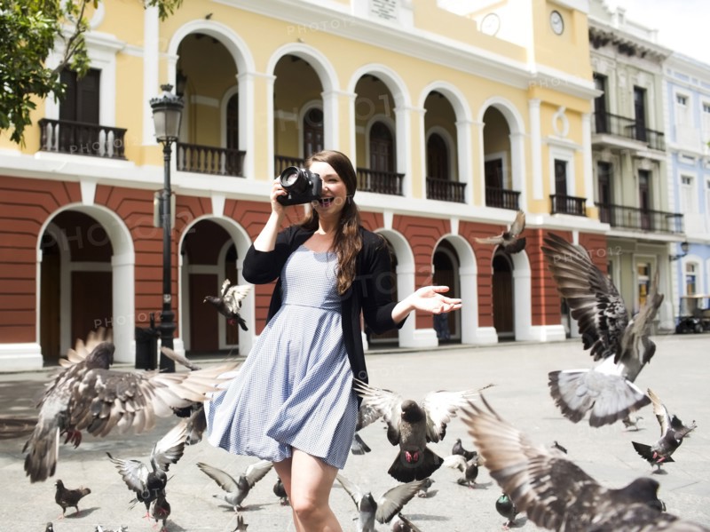 Puerto Rico, San Juan, woman on square among pigeons