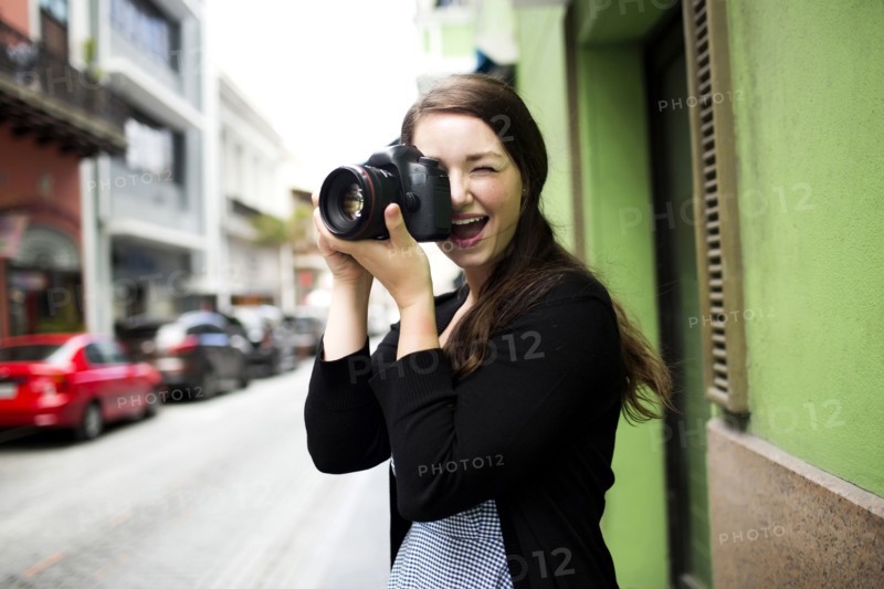 Puerto Rico, San Juan, Woman standing on street and photographing