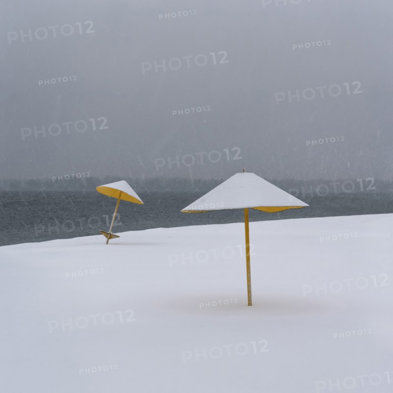 Ukraine, Dnepropetrovsk Region, Dnepropetrovsk city, Snowy beach with sunshades