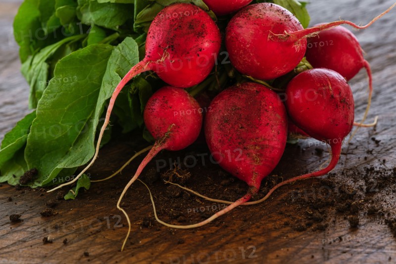 Bunch of red radishes on table