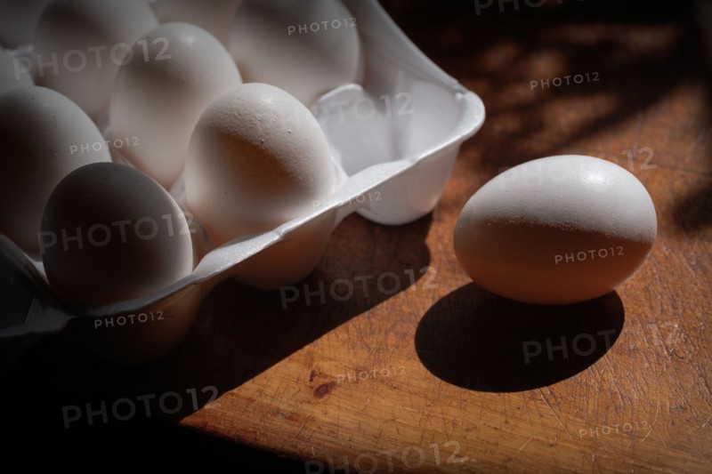 Fresh eggs in carton on table
