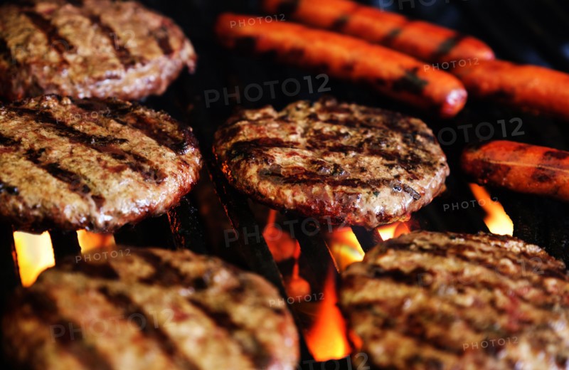 Hamburgers and hot dogs on barbeque grill