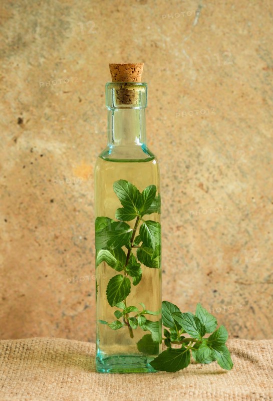 Olive oil bottle with mint leaves
