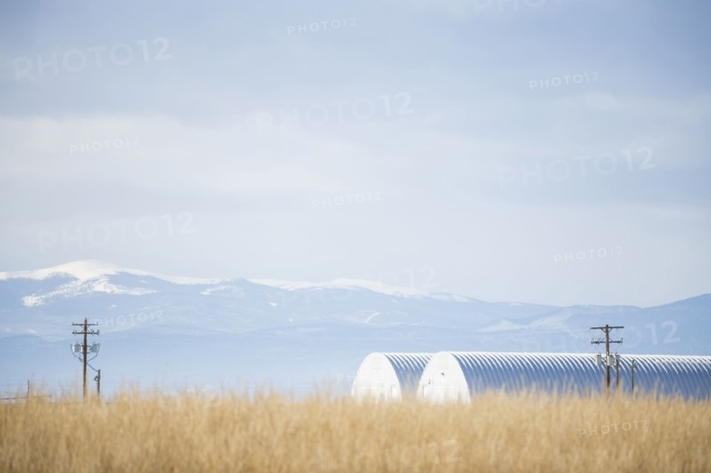 USA, Colorado, Agricultural landscape with snowcapped mountains in background