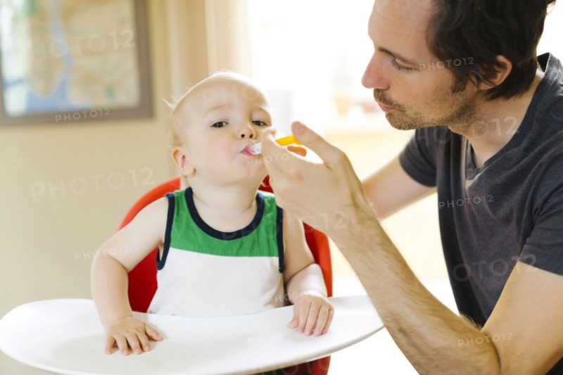 Father applying medicine to son (12-17 months)