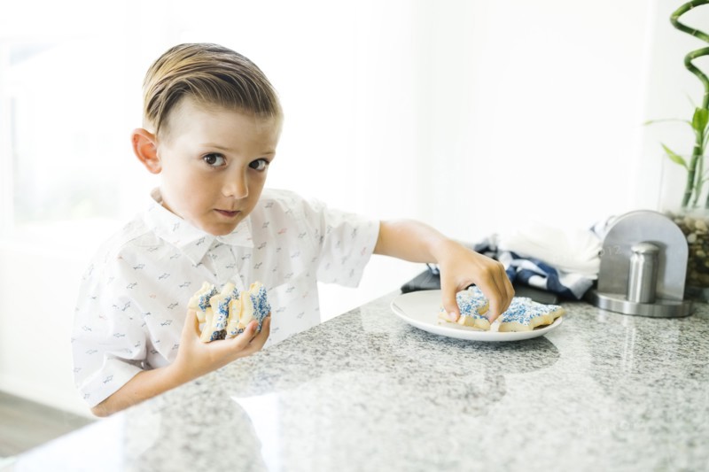 Boy (8-9) stealing cookies