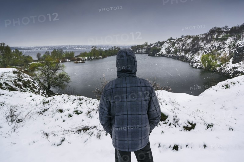 Ukraine, Dnepropetrovsk region, Dnepropetrovsk city, Person looking over winter landscape with lakes