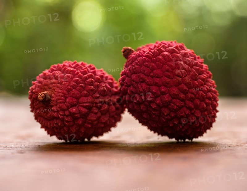 Two lychee on table