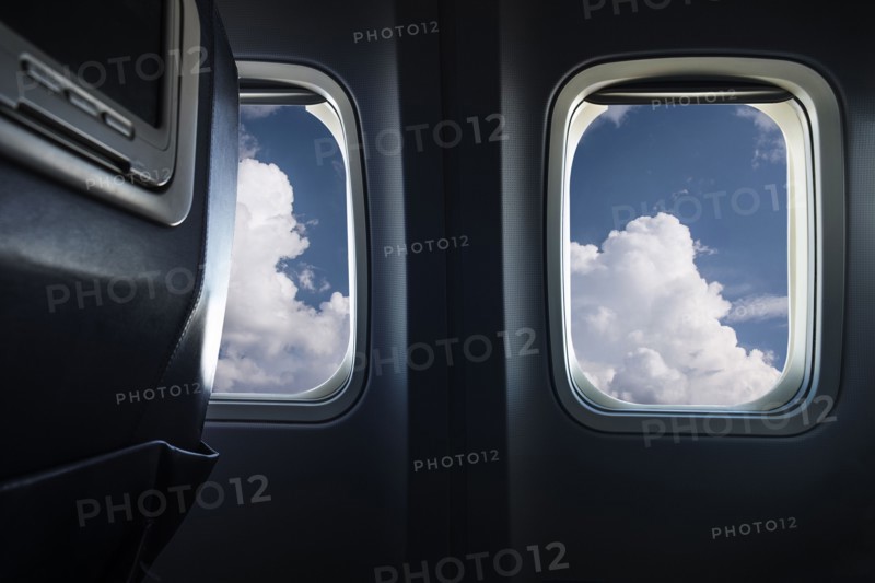Clouds behind airplane window