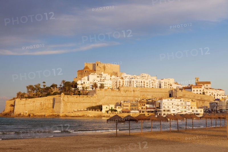 Spain, Valencian Community, Peniscola, Waterfront town on hill with sea and beach in foreground