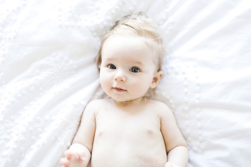 Portrait of baby girl (6-11 Months) smiling, directly above