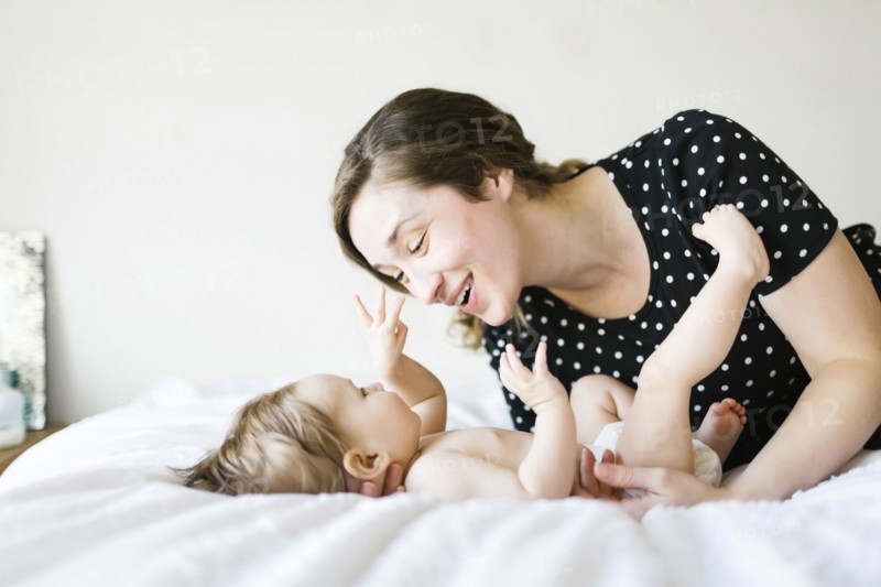 Baby girl (6-11 Months) playing with mother