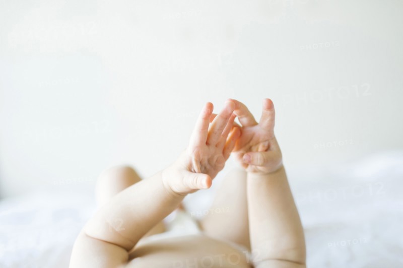 Baby girl (6-11 months) playing in bedroom