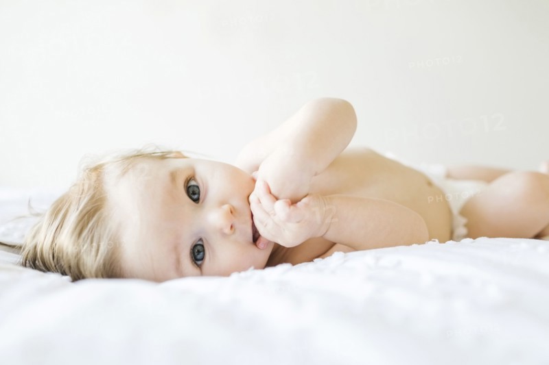 Baby girl (6-11 months) playing in bedroom