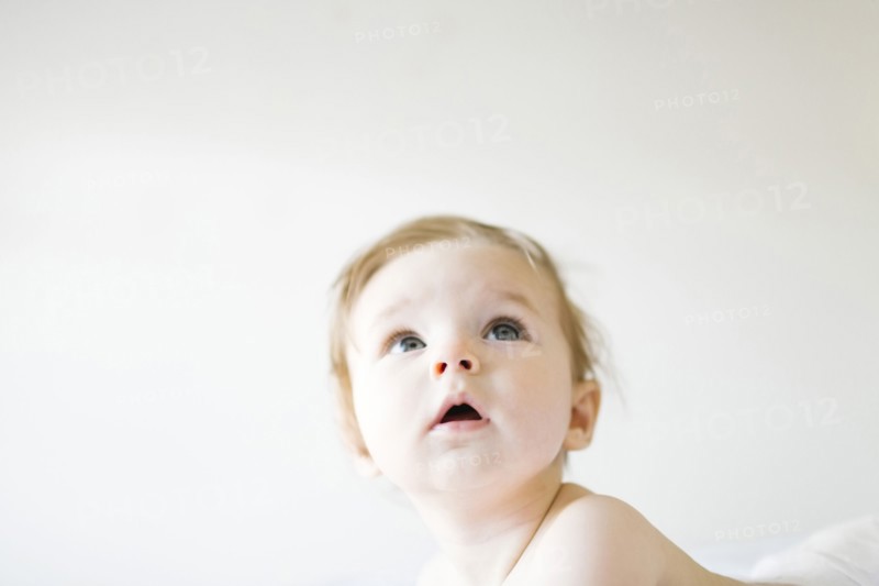 Baby girl (6-11 months) playing in bedroom