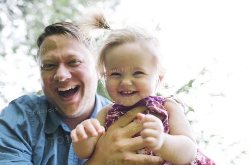 Father playing with baby girl (12-17 months) in backyard