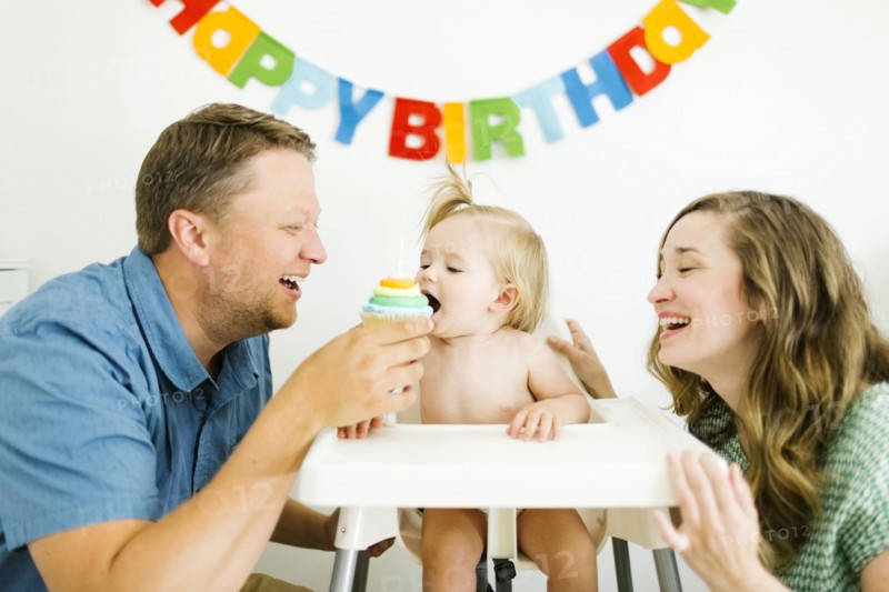 Mother and father celebrating first birthday of daughter (12-17 months)