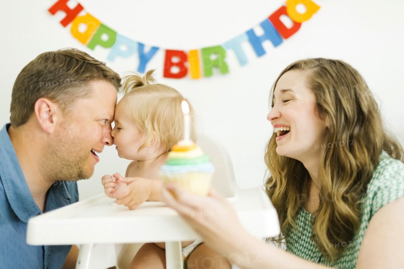 Mother and father celebrating first birthday of daughter (12-17 months)