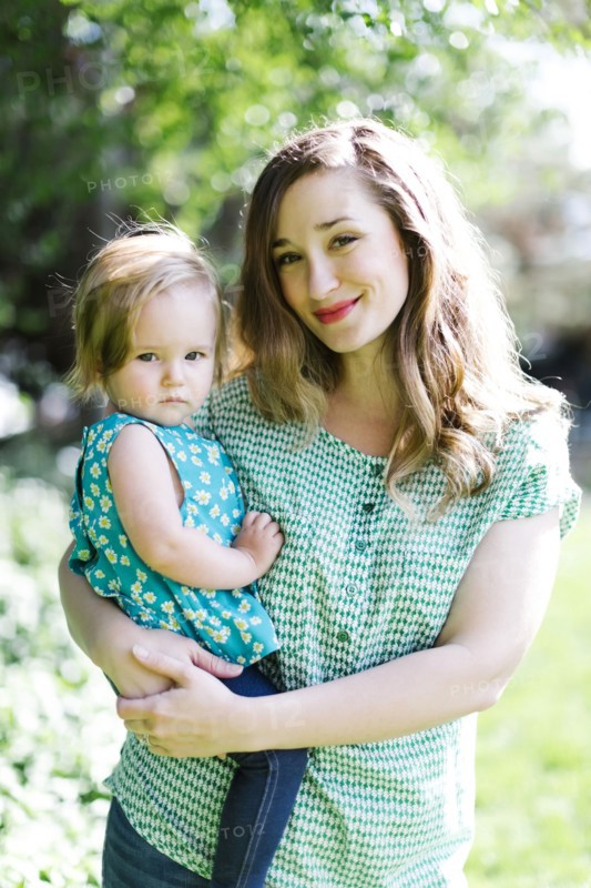 Portrait of mother and baby girl (12-17 months) in backyard