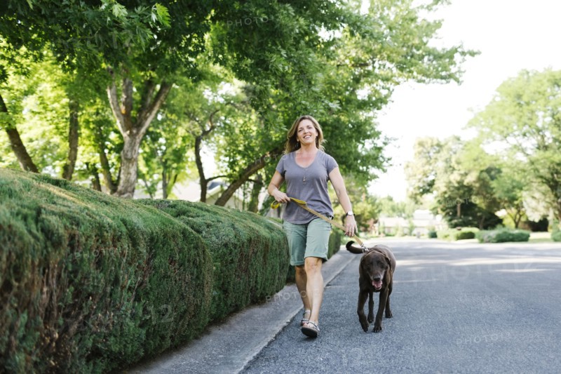 Woman walking with Labrador Retriever