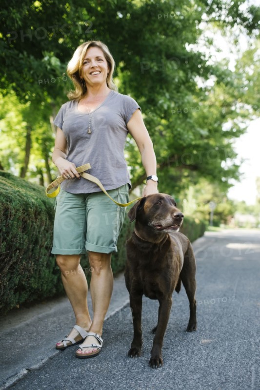 Woman walking with Labrador Retriever