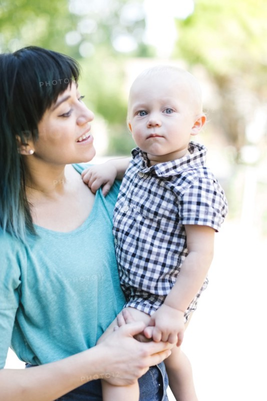 Mother carrying baby boy (12-17 months)