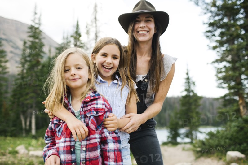 Outdoor portrait of mother with kids (6-7, 8-9) in forest