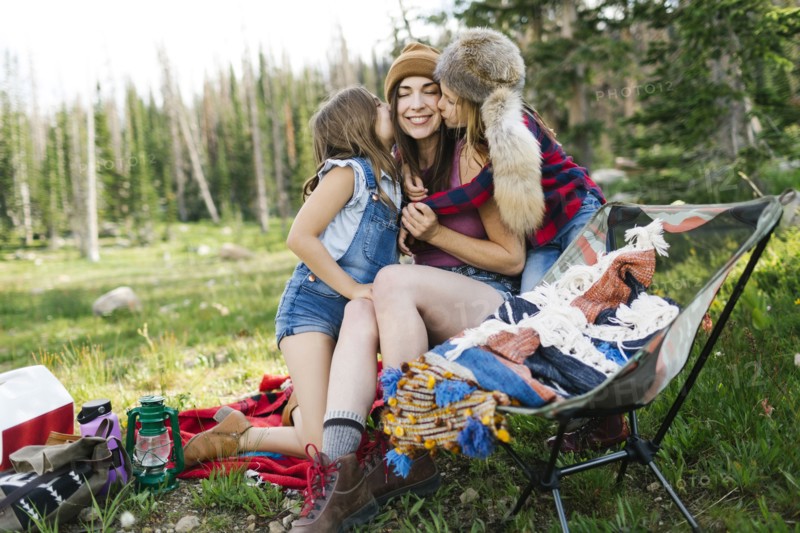 Mother with son (6-7) and daughter (8-9) camping in forest
