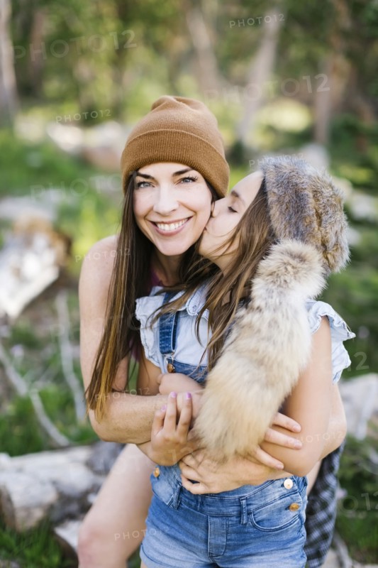 Portrait of mother with daughter (8-9) hiking in forest